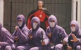 Manos ninja, in front of the purple segment of his multi-colored minions